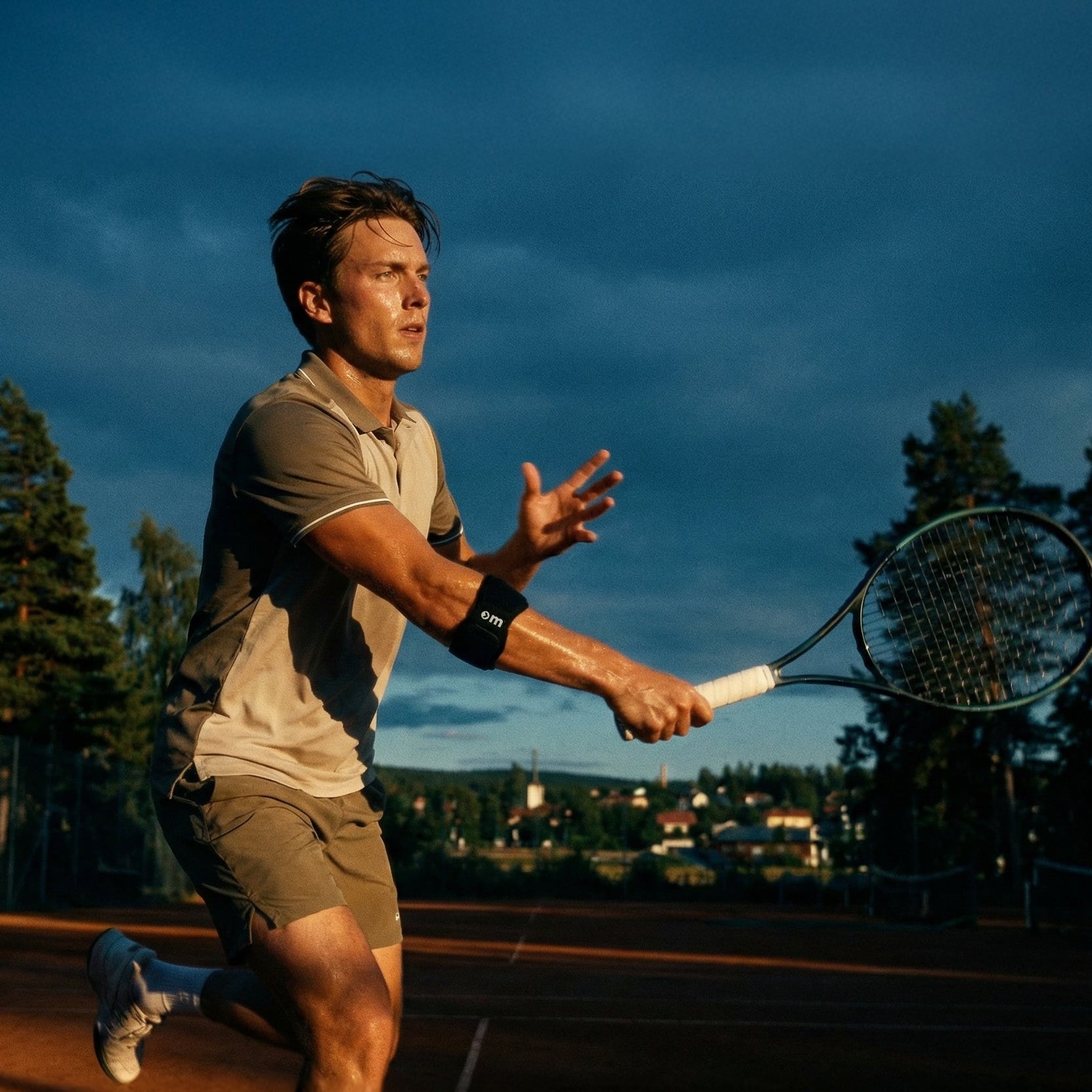 Man playing tennis on a court with a scenic background